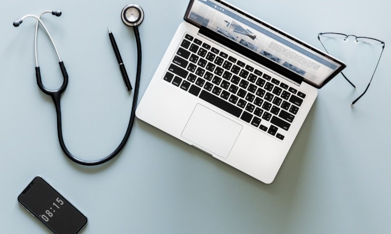 Aerial view of doctor stethoscope and computer laptop