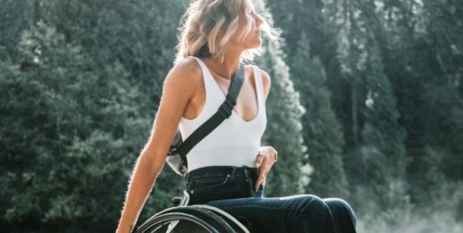 Close up of an inspirational woman in a wheelchair in the woods