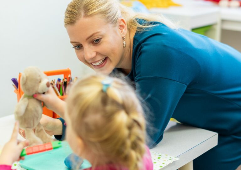 An adult and a child doing occupational therapy activities
