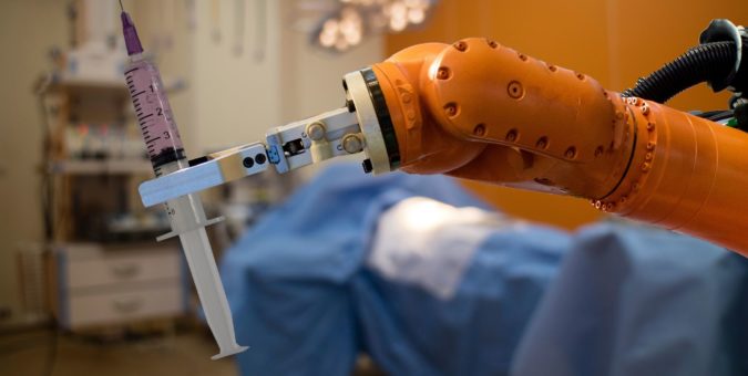 a robot arm holding a syringe