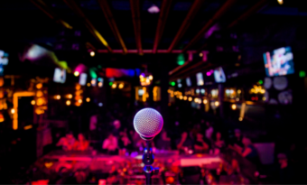 A microphone in front of a packed club