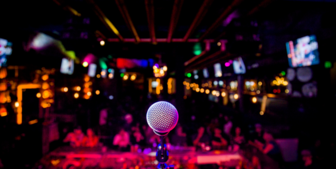 A microphone in front of a packed club
