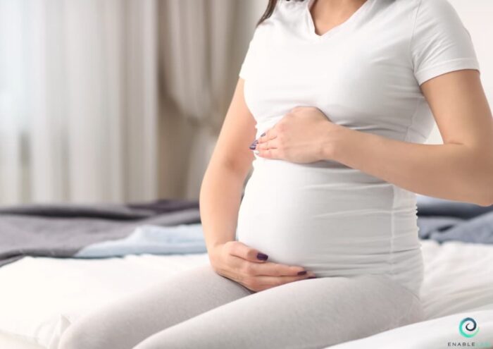 Pregnant woman holds her belly