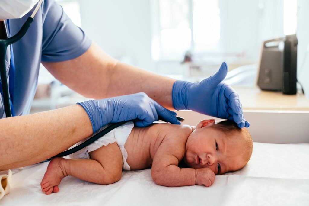 Doctor examining baby back