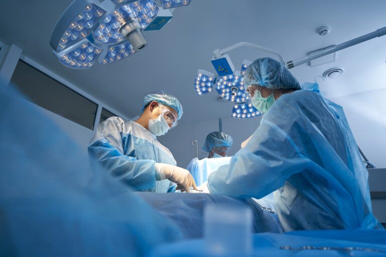 doctors performing abdominal surgery