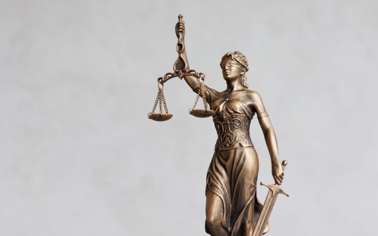 Themis,Goddess,Of,Justice,Statuette,On,Light,Gray,Background.,Symbol