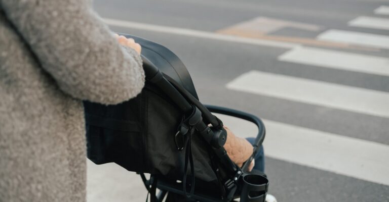 Close,Up,Of,Young,Mother,In,Warm,Coat,Pushing,Baby
