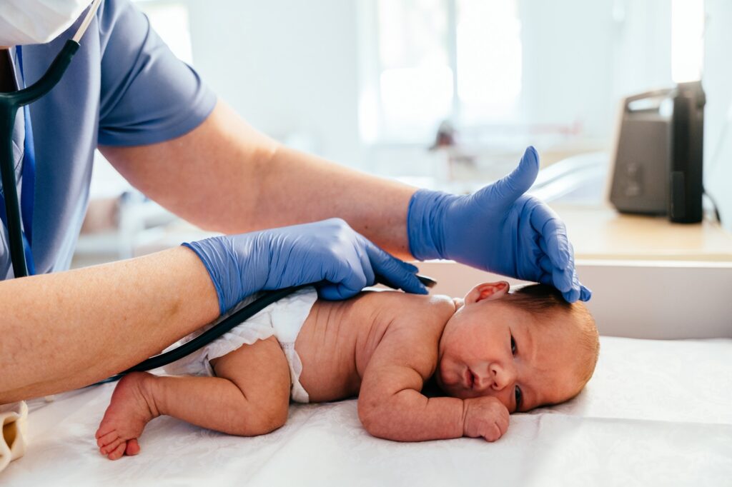 Medical,Professional,In,Protective,Gear,Checking,Back,Of,Newborn,Baby