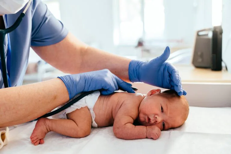 Medical,Professional,In,Protective,Gear,Checking,Back,Of,Newborn,Baby