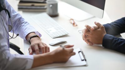 Closeup,Doctor,Giving,An,Advice,To,His,Patient,While,Sitting