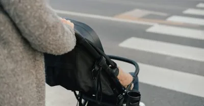 Close,Up,Of,Young,Mother,In,Warm,Coat,Pushing,Baby