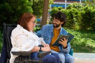 Happy,Friends,Sharing,A,Moment,Of,Studying,Outdoors,-,Wheelchair