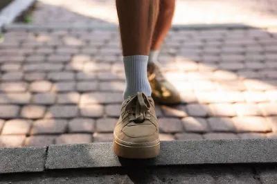 Young,Man,With,Stylish,Shoes,Before,Running,Outdoors,,Closeup