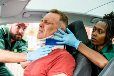 Paramedics,Assist,An,Injured,Man,In,A,Car,,Fitting,A